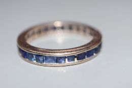 A gilt white metal and sapphire set full eternity ring, size N, gross 3.4 grams.CONDITION: Wear to