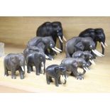 Ten Indian carved ebony elephants, with ivory tusks, c.1900, tallest 16cm