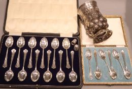 A cased set of eleven George V silver teaspoons and one other matched teaspoon, a cased set of six