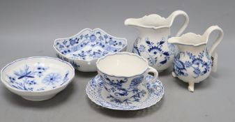 Two Meissen jugs, a cup and saucer and two dishes in blue and white onion pattern, tallest