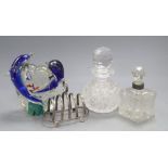 An Italian glass model of dolphins inset with fish, two scent bottles and a silver toast rack