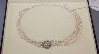 A modern triple strand cultured pearl choker necklace, with 9ct gold and culture pearl cluster