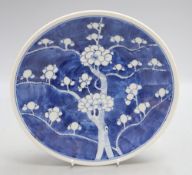 A 19th century Chinese blue and white prunus pattern dish, Kangxi mark, diameter 27cmCONDITION: