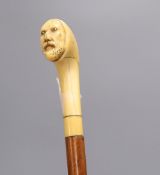 A Druid's head carved cane, c.1860, length 85cm