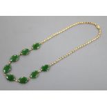 A mid 20th century Chinese 18k yellow metal and oval jade set necklace, (a.f.), length 38cm, gross