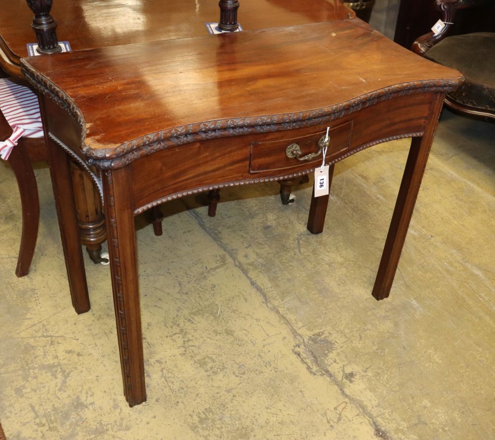 A George III style carved mahogany serpentine tea table with folding top, W.90cm, D.46cm, H.