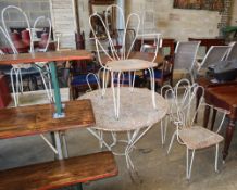 A garden table and six chairs, France, c.1920, table diameter 94cm, H.72cmCONDITION: All pieces have