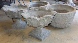 Two pairs of cast stone garden urns, larger 56cm diameter, H.36cm