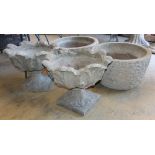 Two pairs of cast stone garden urns, larger 56cm diameter, H.36cm