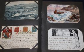A quantity of postcards in an album