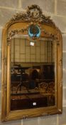 A late 19th century French gilt carved wood and gesso wall mirror, the plate surmounted by a tied