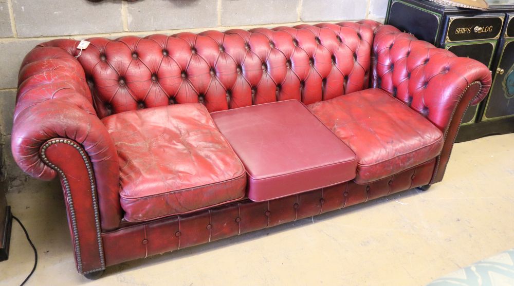 A buttoned red leather Chesterfield settee, W.200cm, D.84cm, H.66cmCONDITION: The original leather