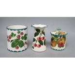 A Wemyss lidded jam pot, a vase decorated with strawberries and another fluted vase decorated with