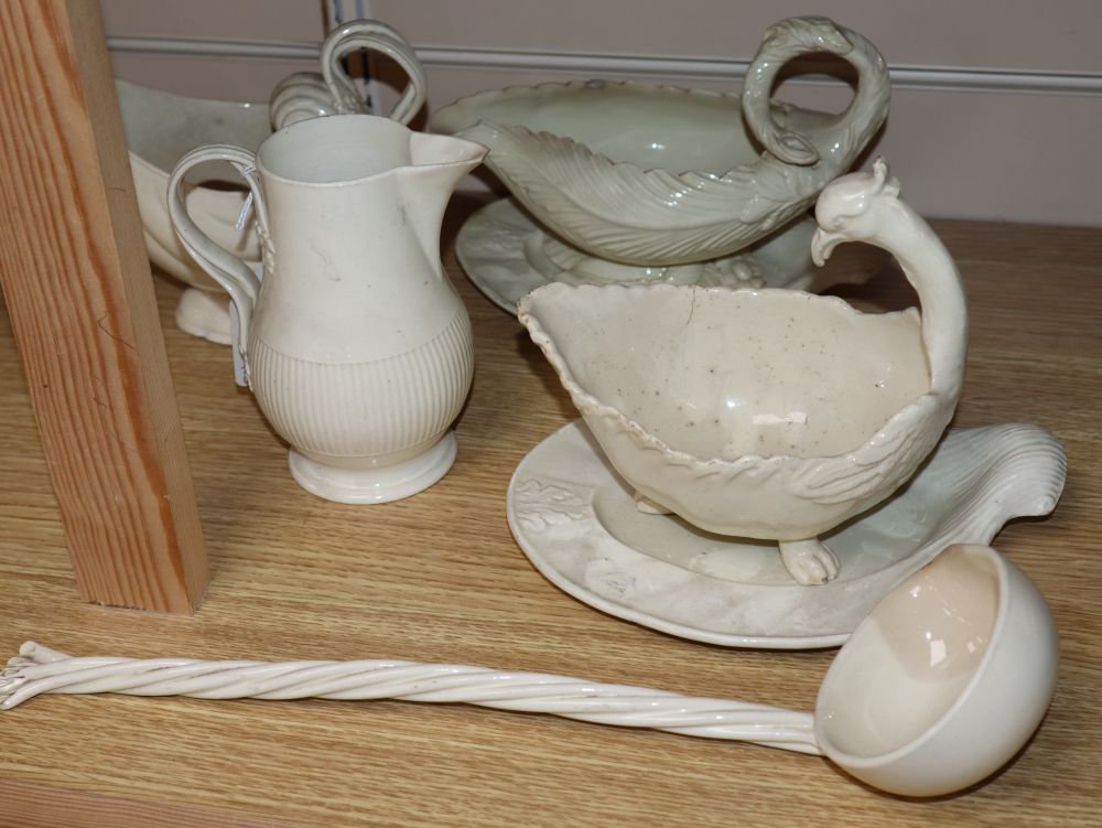 A late 18th century creamware sauce boat and stand, another similar with stand, a sauceboat, jug and