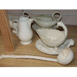 A late 18th century creamware sauce boat and stand, another similar with stand, a sauceboat, jug and