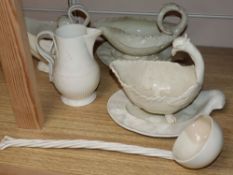 A late 18th century creamware sauce boat and stand, another similar with stand, a sauceboat, jug and