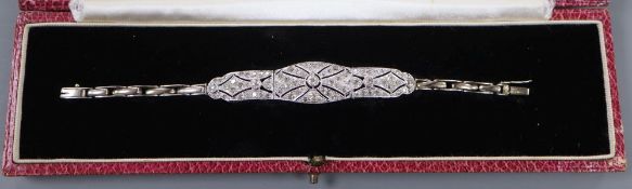 A 1930's pierced white metal and diamond set bracelet, on an 18ct expanding bracelet, 14.4cm ++,