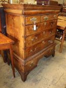 An early 19th century walnut and crossbanded chest on stand, later bracket feet, W.106cm, D.57cm,