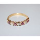 A modern 18ct, three stone diamond and four stone ruby set half hoop ring, size P/Q, gross 3.7
