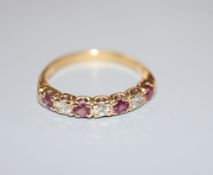 A modern 18ct, three stone diamond and four stone ruby set half hoop ring, size P/Q, gross 3.7