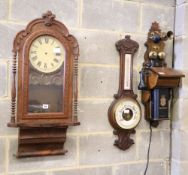 An American walnut wall clock, a late Victorian aneroid wheel barometer and a vintage style