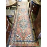 A Persian red ground runner, c.1860, 460 x 100cmCONDITION: Worn and faded throughout, with some