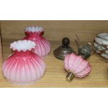 A pair of Victorian oil lamp glass shades, one with reservoir