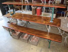 A vintage pine and metal folding garden table and two benches, table W.220cm, D.50cm, H.