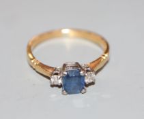 An 18ct, sapphire and diamond three stone ring, size N, gross 2.7 grams.CONDITION: Minor scratches