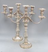 A pair of old Sheffield plate two branch three light candelabra, height 43cm