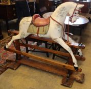 An early 20th century Ayres type carved wood dapple grey rocking horse on pine safety frame, H.