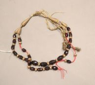 An Indian? facetted garnet bead necklace on damaged thread necklace, approx. 78cm.