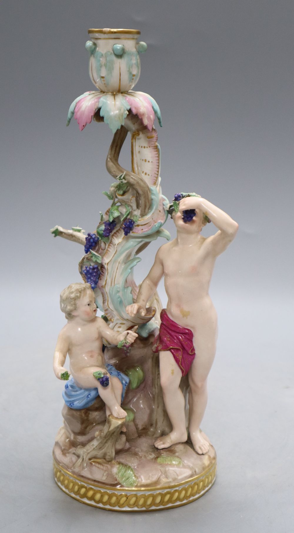 A Meissen 'Bacchus and cherub' candelabrum, 19th century, model no 1190, H. 29cmCONDITION: The