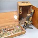 A Negretti and Zambra cased brass microscope and various specimen slides