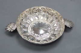 An Edwardian repousse silver shallow bowl, with fluted lug handles, Wakely & Wheeler, London,