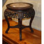 A 19th century Chinese carved hardwood marble top jardiniere stand, 48cm diameter, H.48cm