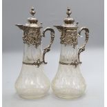 A pair of 19th century German 800 white metal mounted glass claret jugs, of tapered bulbous form
