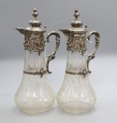 A pair of 19th century German 800 white metal mounted glass claret jugs, of tapered bulbous form
