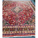 A Mashad red ground carpet, 380 x 290cm