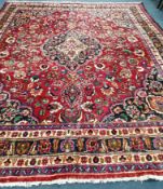 A Mashad red ground carpet, 380 x 290cm