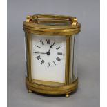 An oval brass carriage clock, height 12cm (handle down)