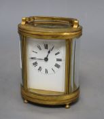 An oval brass carriage clock, height 12cm (handle down)