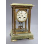 A four glass onyx and brass Corinthian columned clock, height 50cm width 19cm