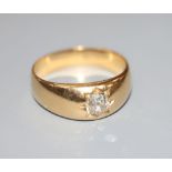 A late Victorian yellow metal and gypsy set solitaire diamond ring, size R, gross 7 grams.CONDITION: