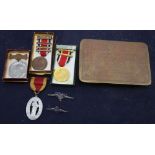 A WWII tobacco tin and medals