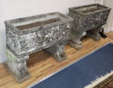 A near pair of reconstituted stone garden planters, on lion's paw and scroll moulded supports, W.