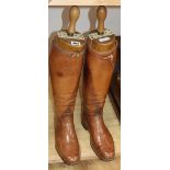 A pair of early 20th century tan leather boots and boot trees, trees marked Major G.L.W.K. Bird