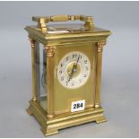 An early 20th century French lacquered brass oversized carriage clock, striking on a gong,