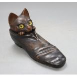 An early 20th century carved wood 'cat in a shoe' inkwell, with hidden compartments, length 20cm