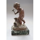 A bronze putto blacksmith, signed H. Capy, on marble base, height 15cm